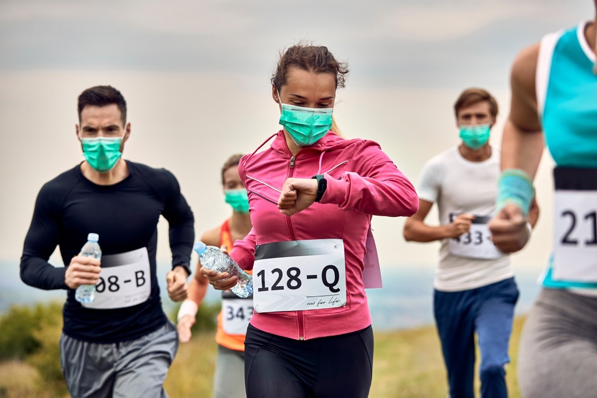 People running a race wearing face masks