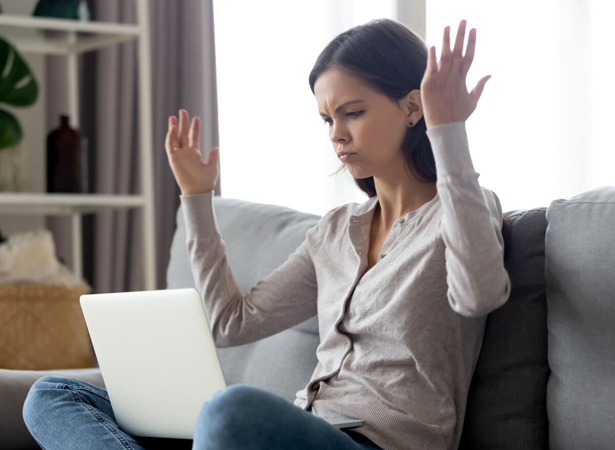 Annoyed woman cranky on laptop