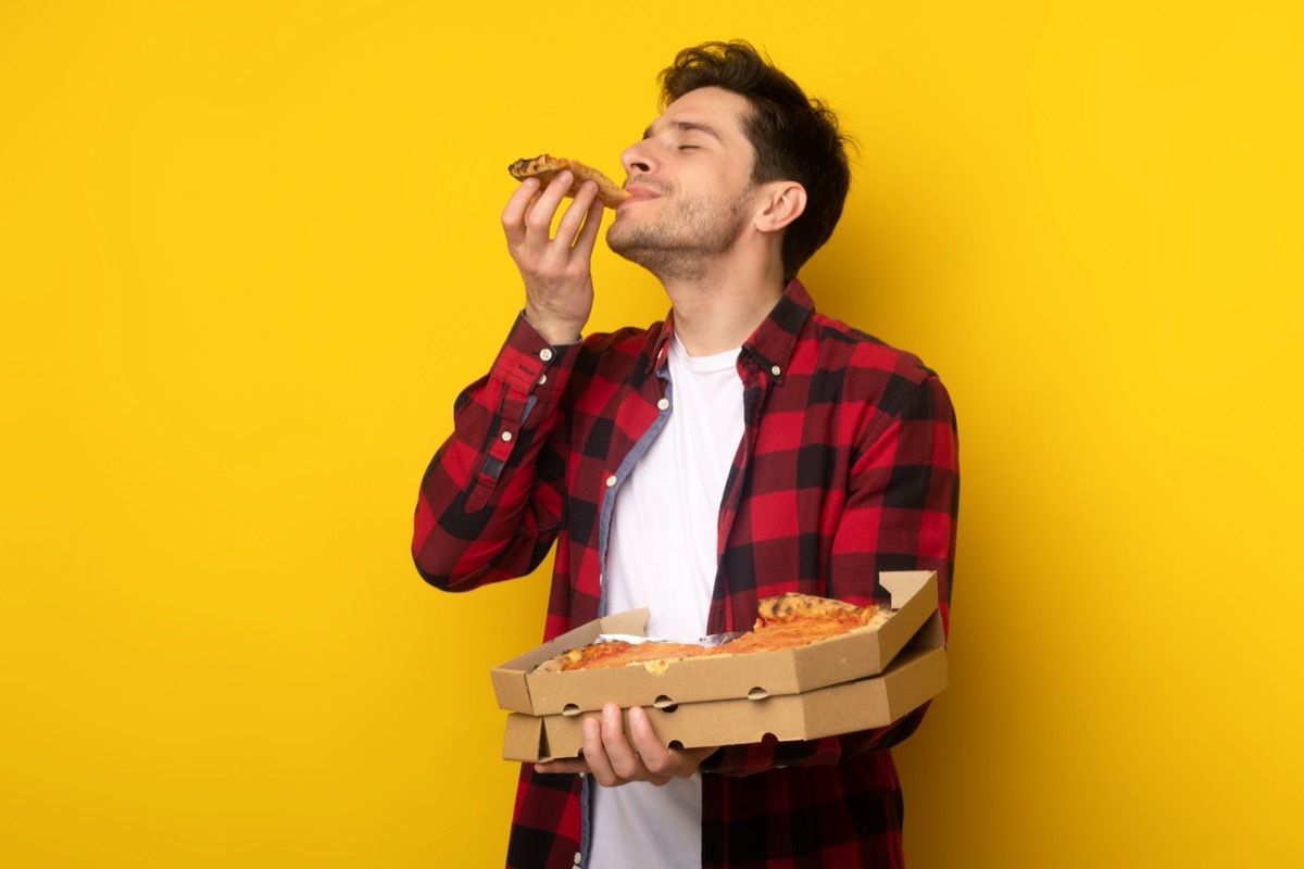 man eating pizza