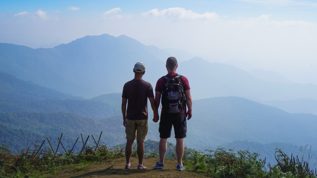 Couple standing at summit on hike