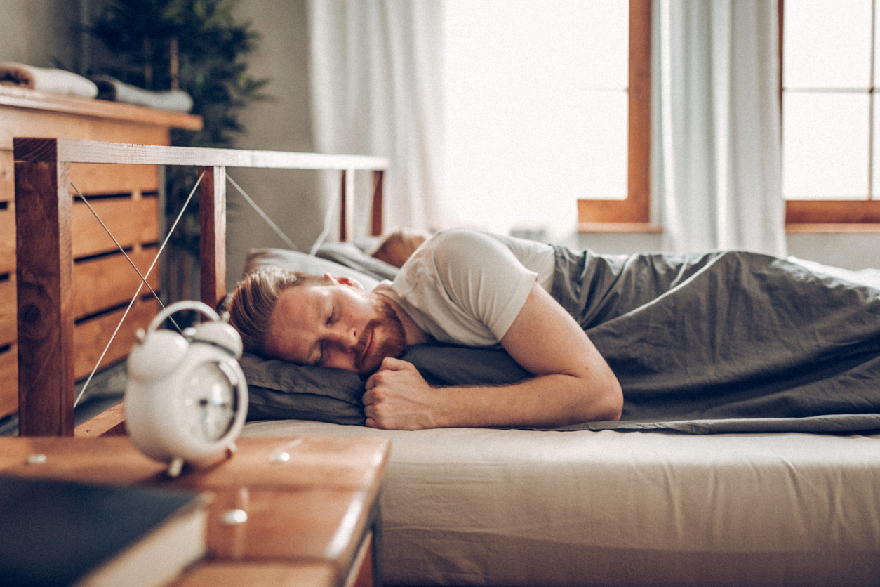 young man sleeping in bed