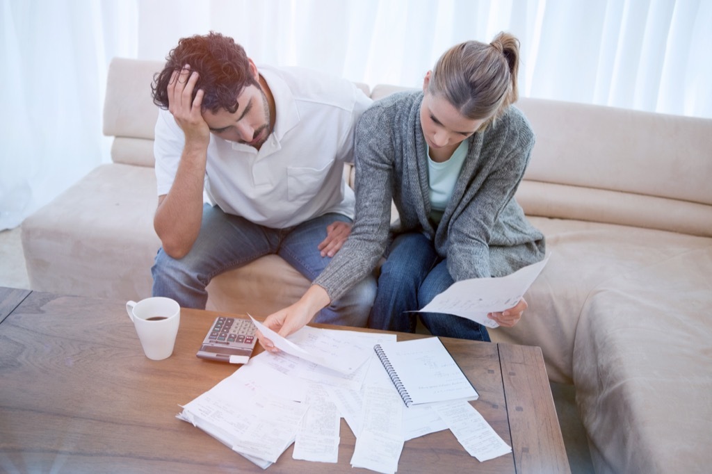 Unhappy Couple doing taxes {Cons of Owning a Big House}