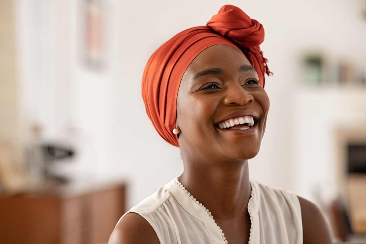 Woman laughing in her home. 