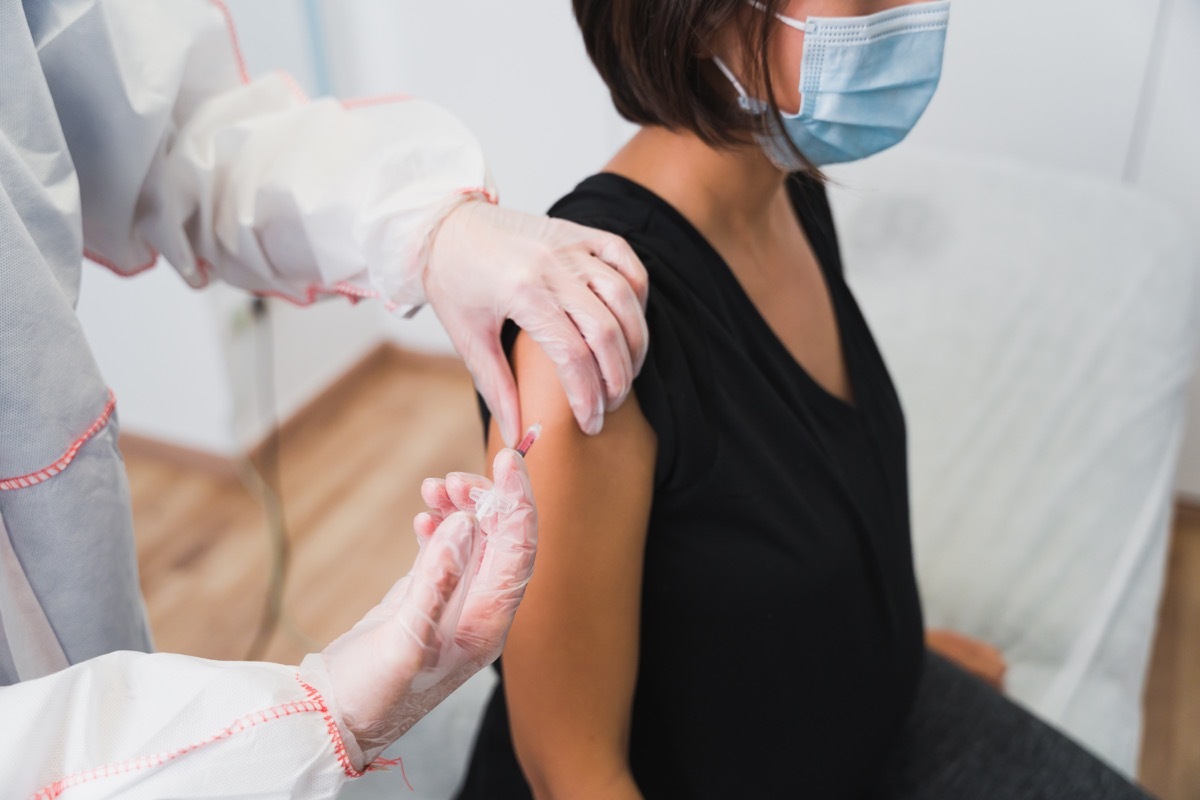 Female Doctor giving a vaccine to a pregnant woman against Covid 19 or flu or whooping cough. COVID 19 coronavirus vaccine.