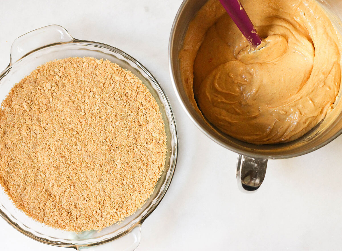 Pumpkin cheesecake about to poured into the baked graham cracker crust