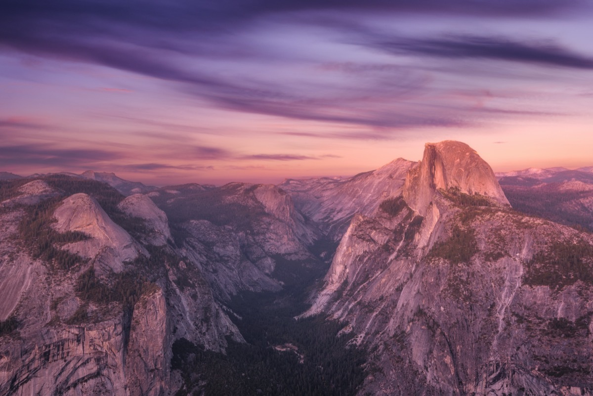 grey domes and the Sierra Nevada Mountains at sunset in Yosemite National Park, California