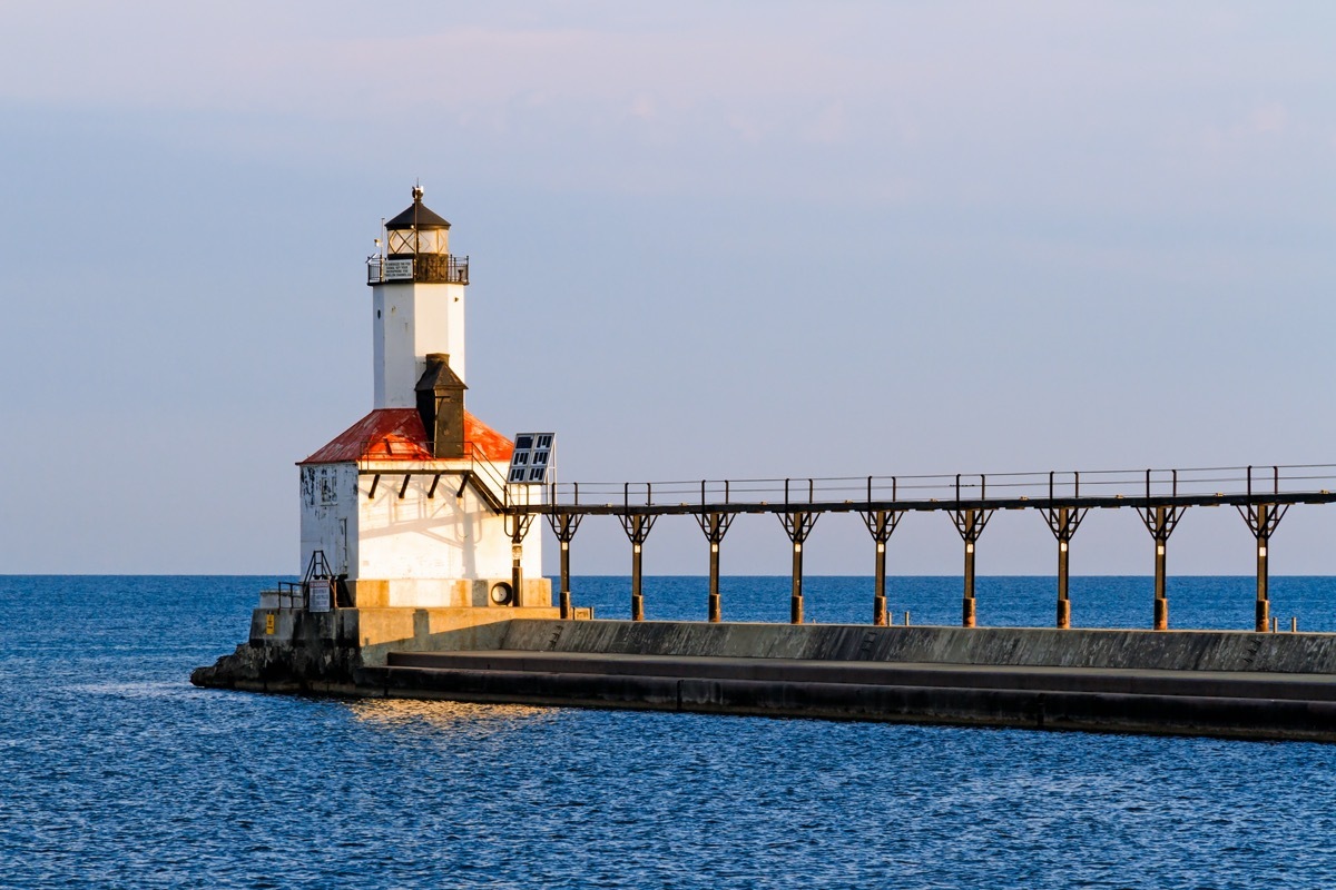 the East Pierhead Lighthouse and an elevated pier on a lake in Michigan City, Indiana