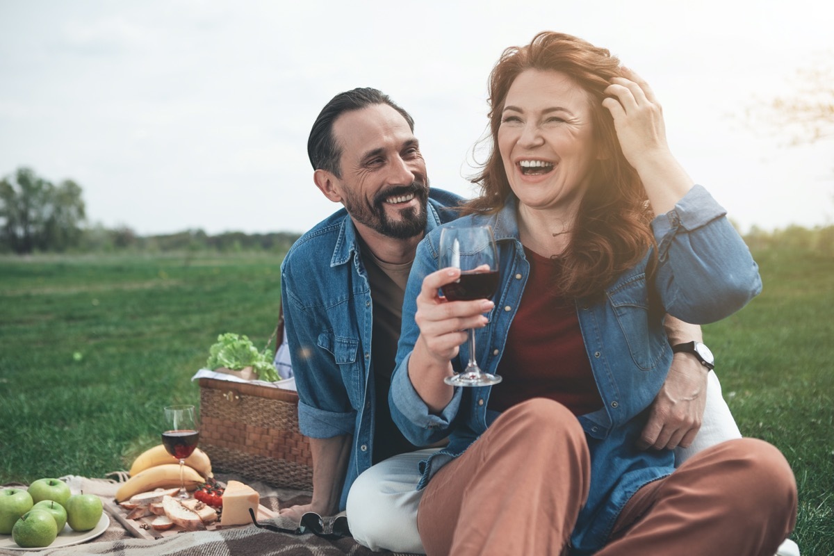 Middle-aged man and woman on picnic date