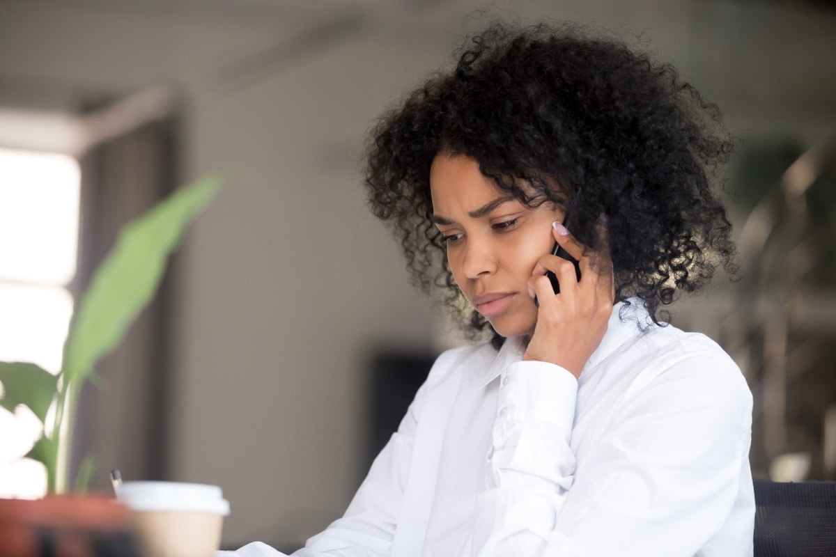 woman apologizing but confused over the phone