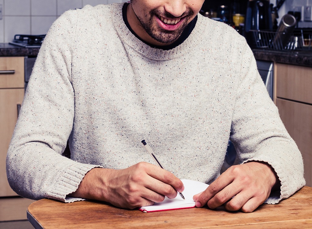 man using his journal