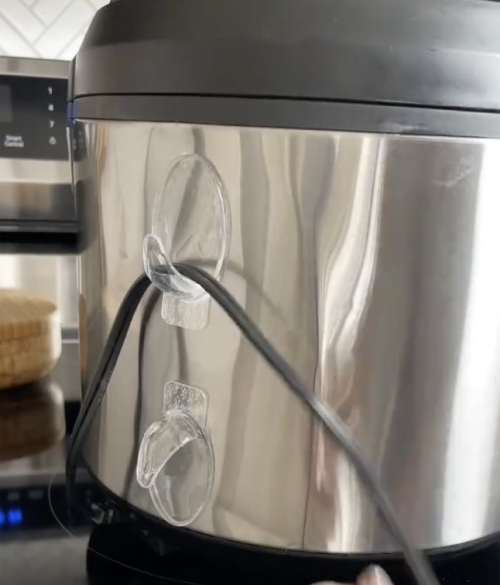 Clear hooks being used to organize appliance cords