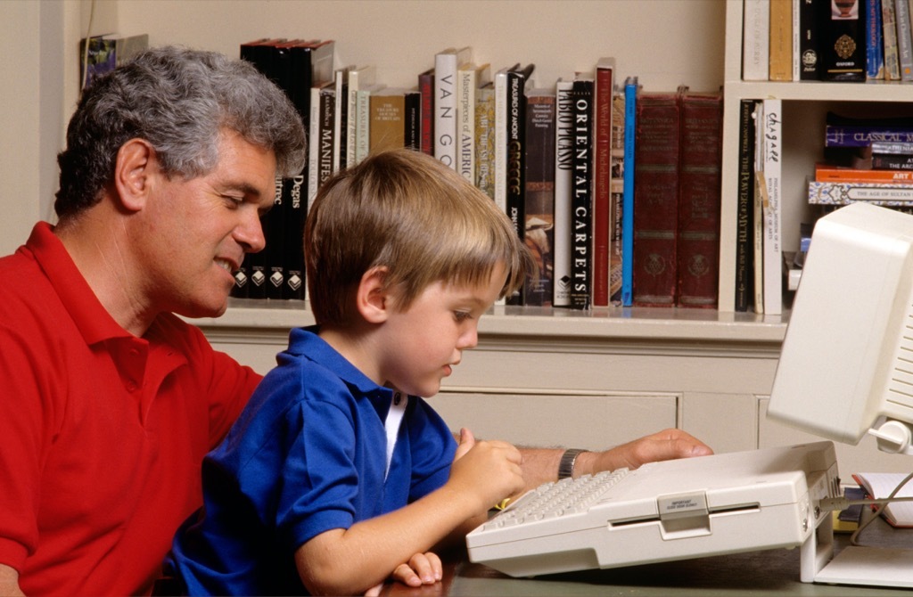 father and son on dial up computer in the 1990s