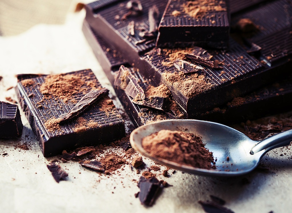 Shaved dark chocoloate in spoon with dark chocolate bars