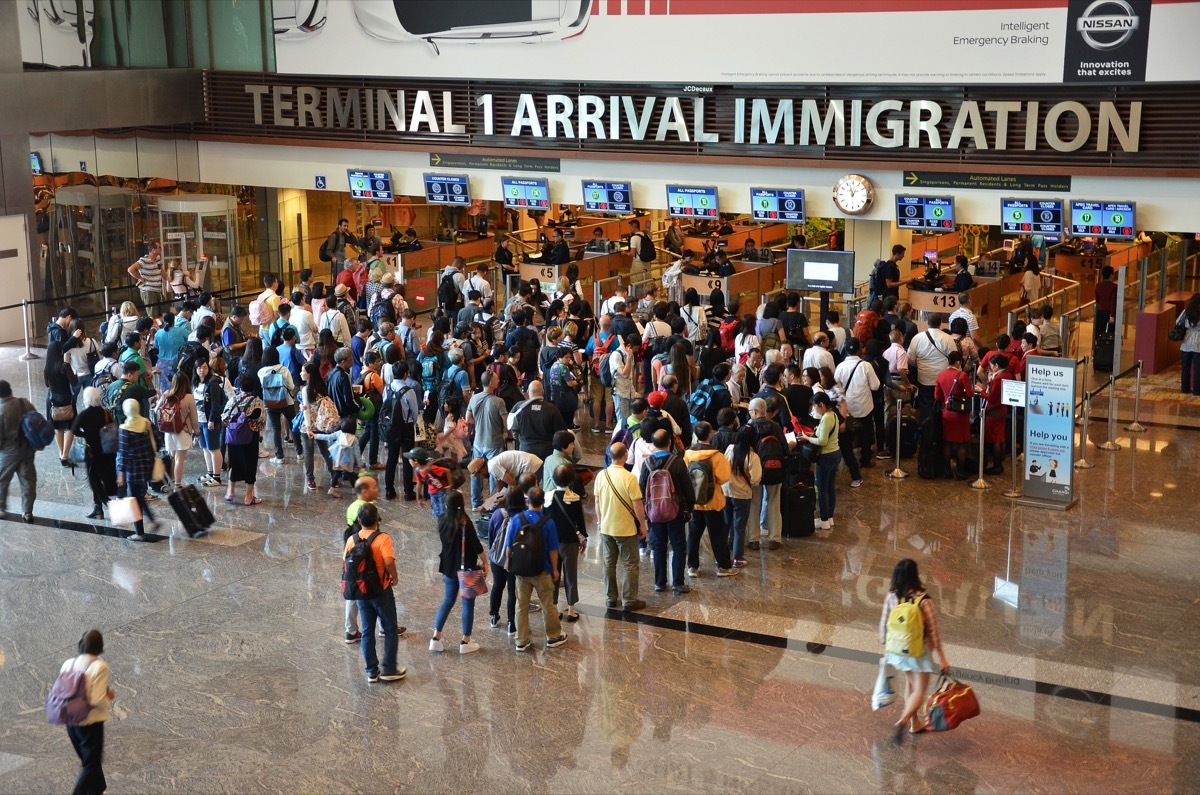 people lined up to go through airport immigration