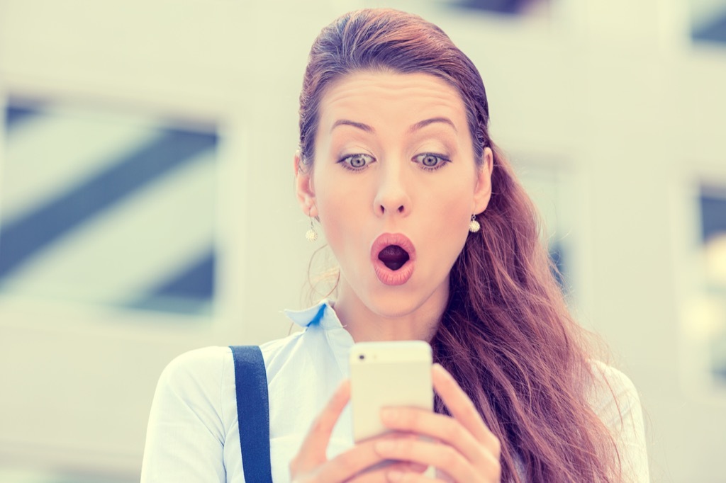 woman surprised anxious on her phone