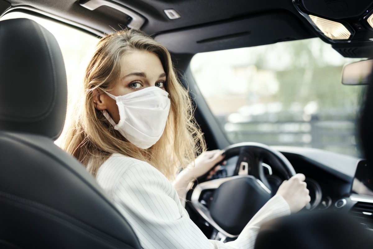 Businesswoman is using a car while working