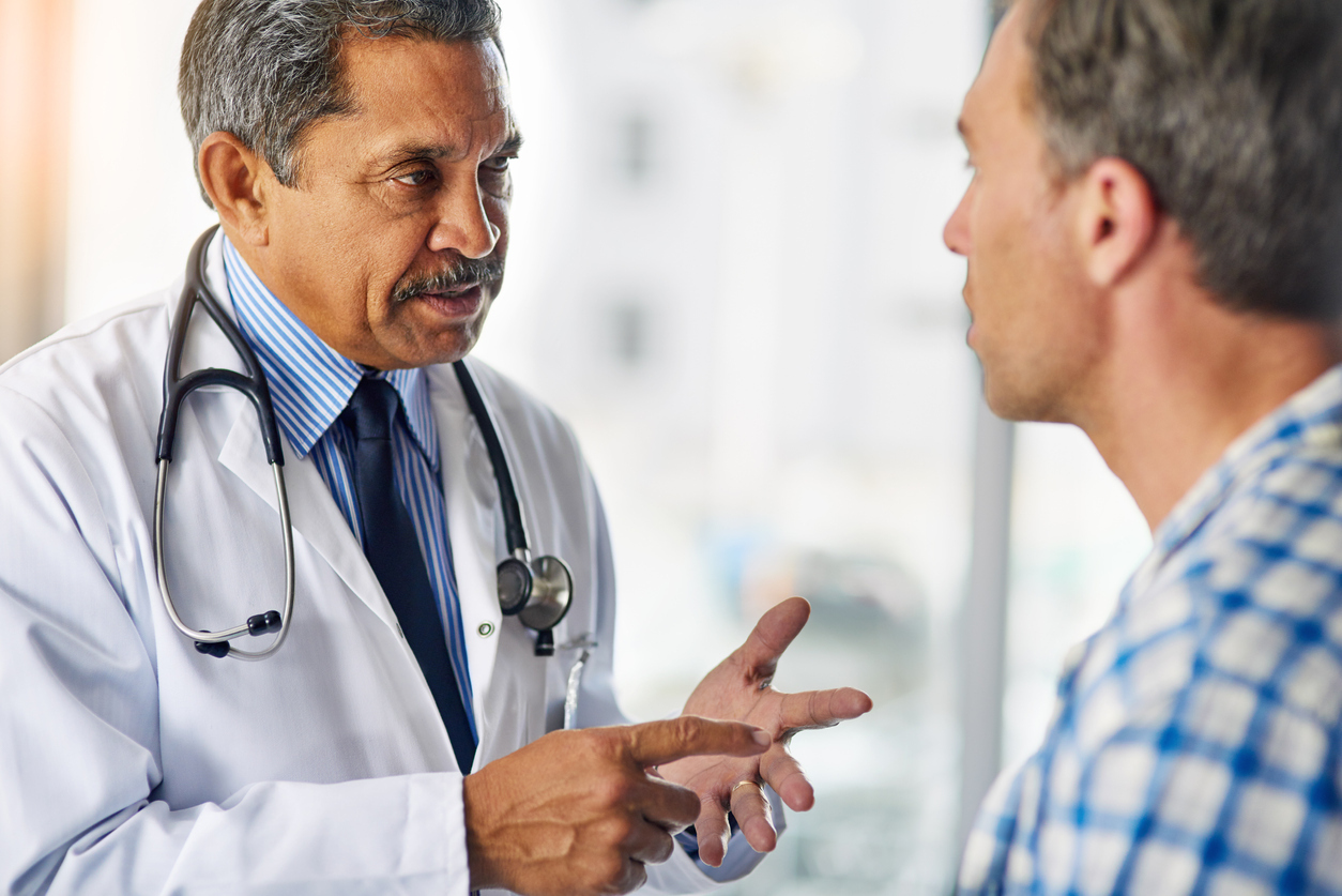 Doctor explaining something to a patient.