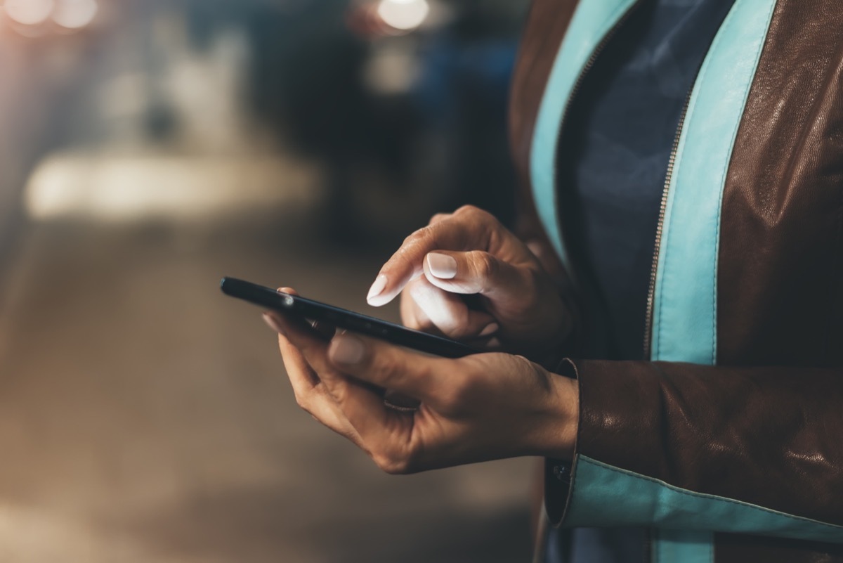 close up on woman's hands using smartphone