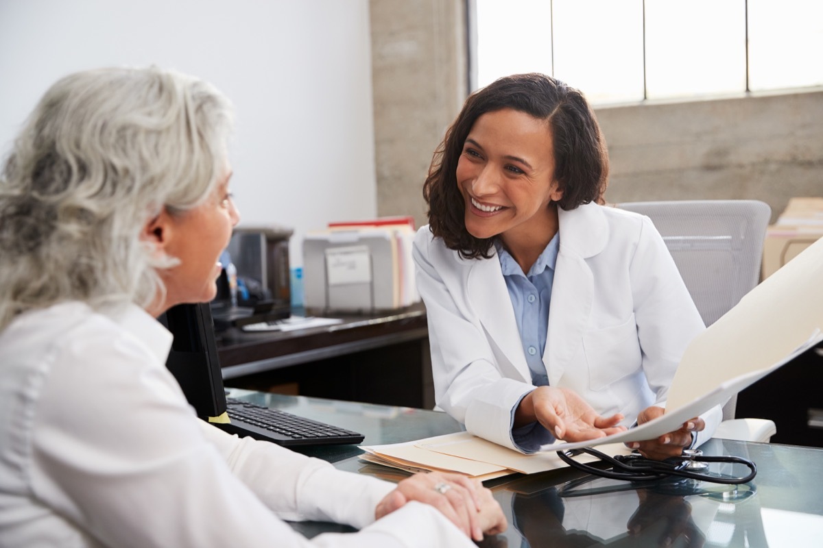 female doctor in consultation with senior patient