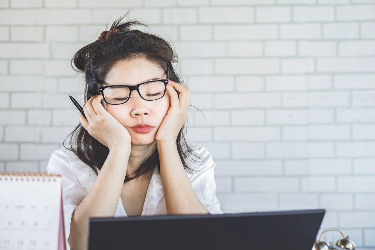 young-woman-sleeping-at-her-desk