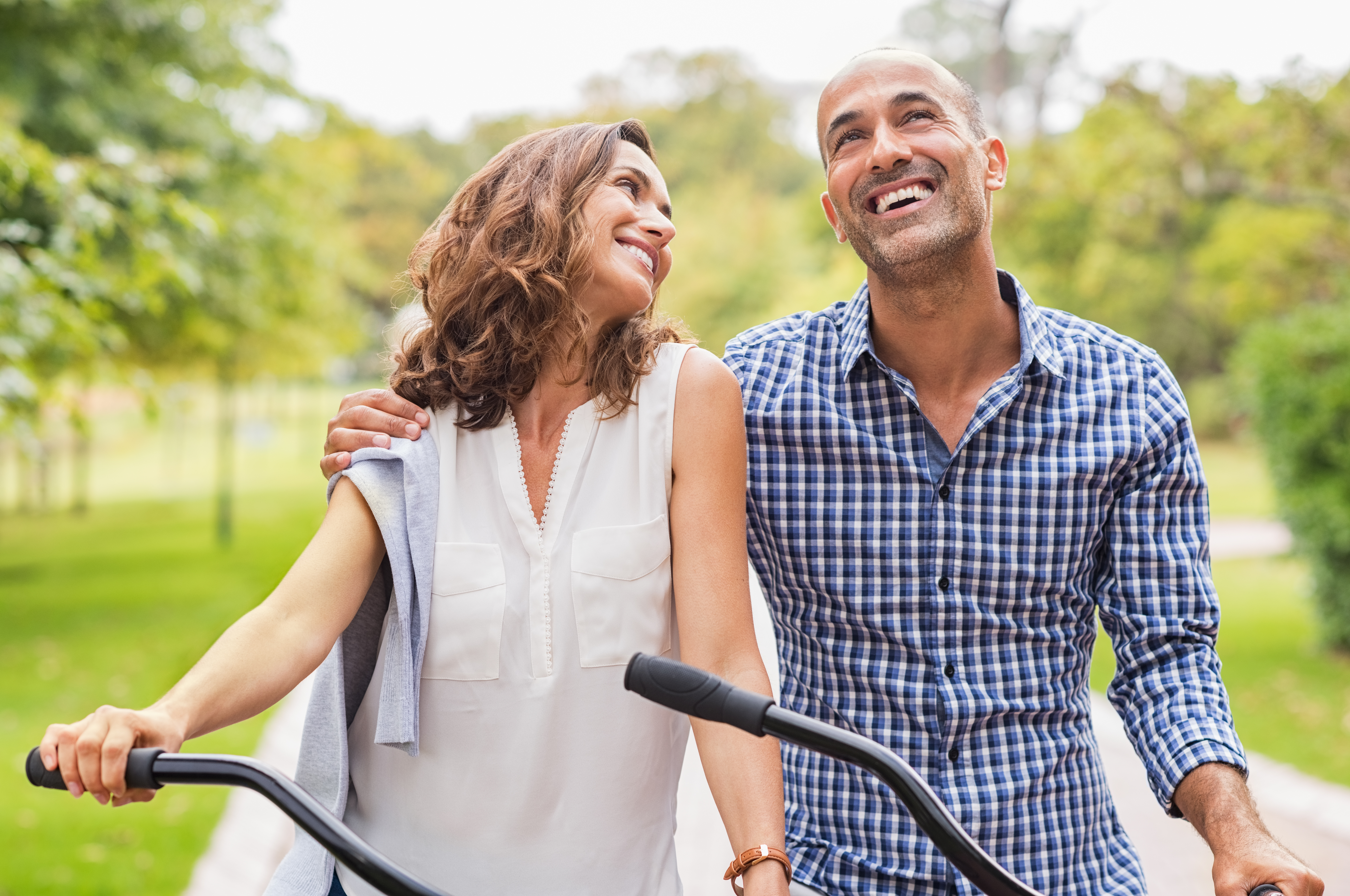 man and woman smiling on bikes, what he wants you to say