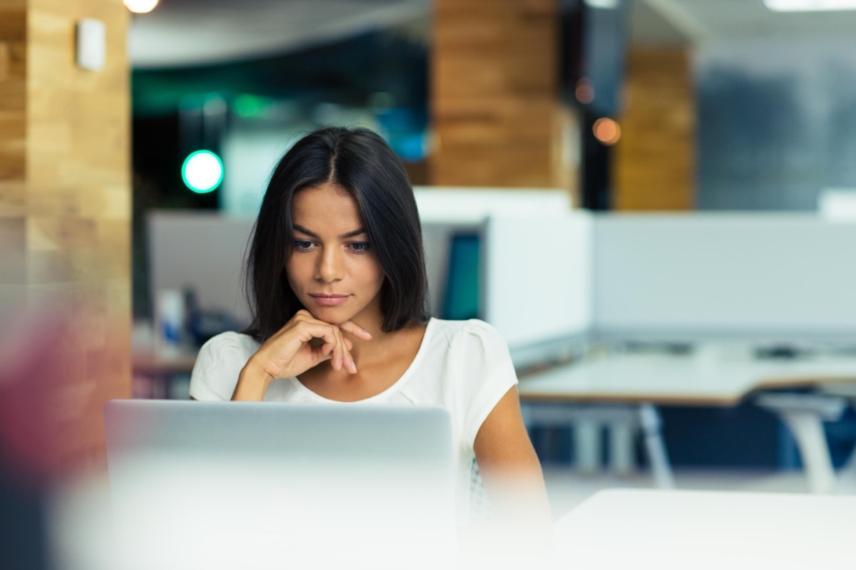 Woman looking at laptop