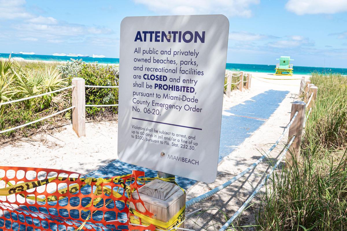 Miami Beach closed with coronavirus pandemic warning sign