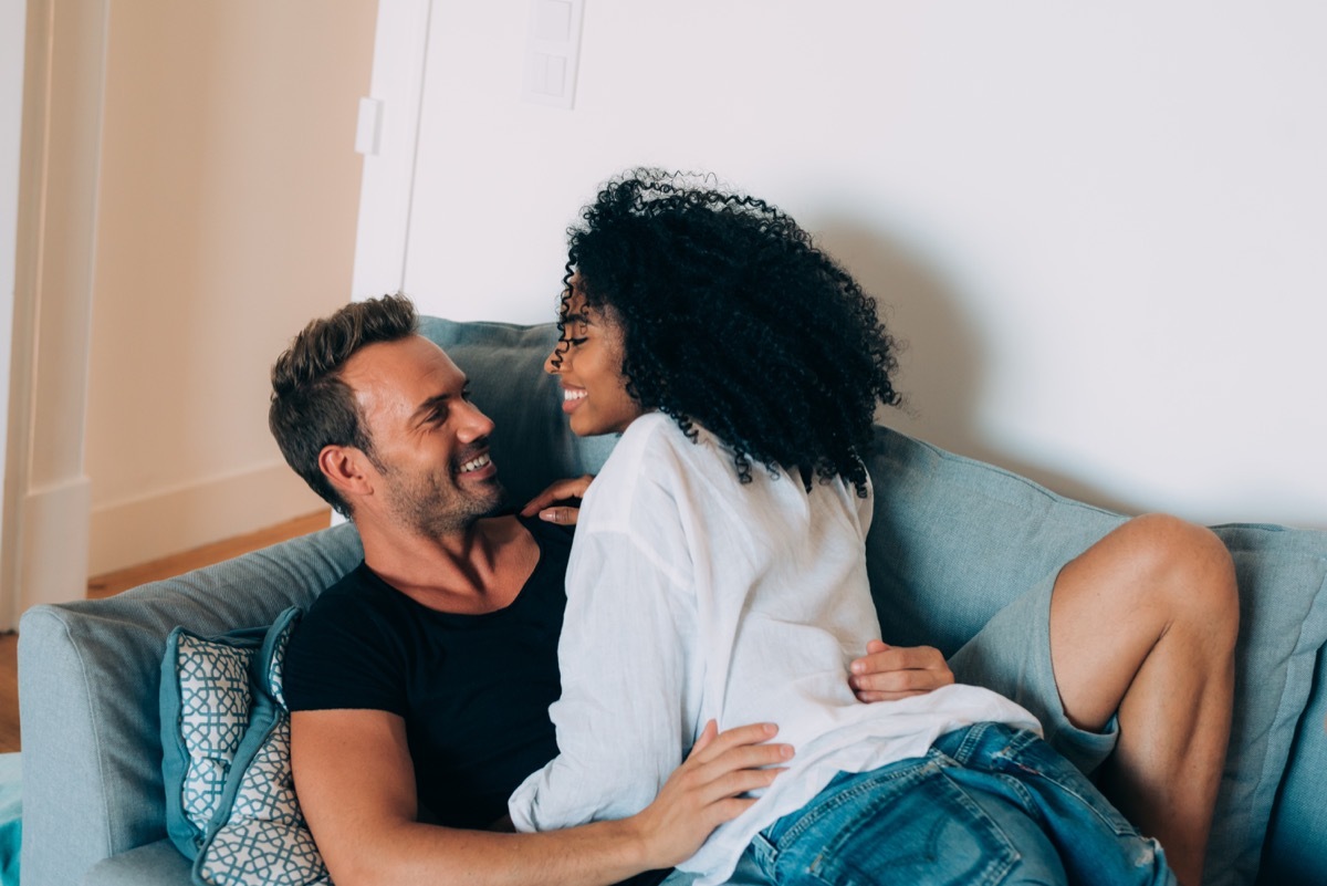 Couple kissing on couch