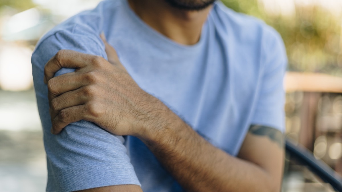 man with upper arm pain after vaccine