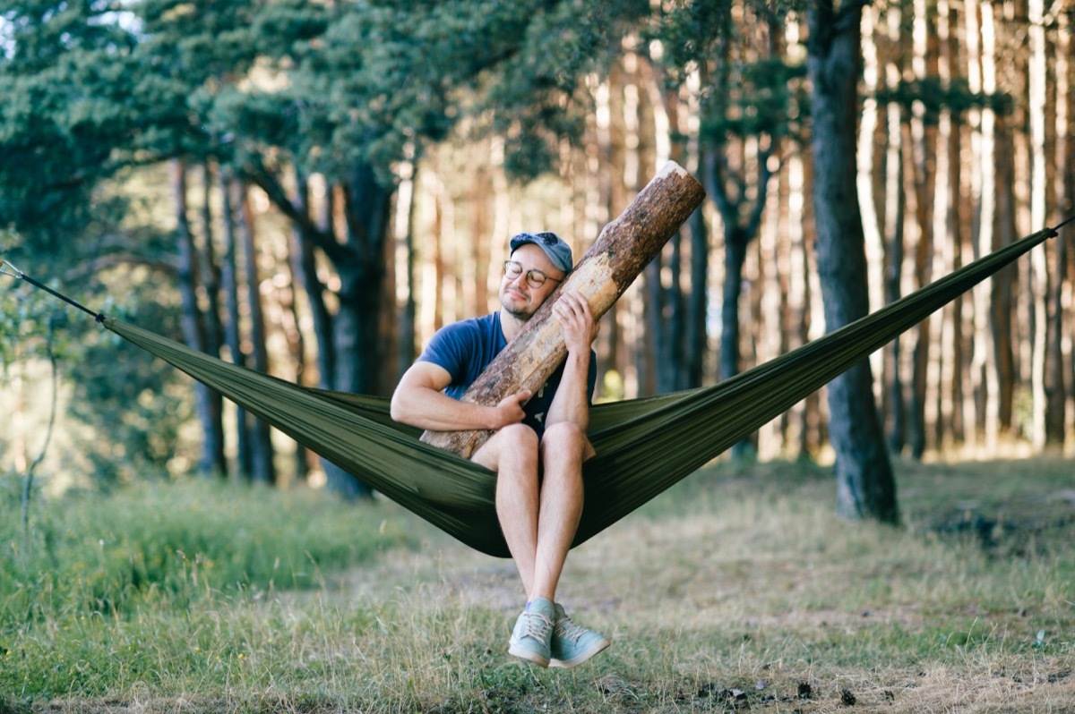 Man Hugging a Tree in a Hammock Funny Stock Photos