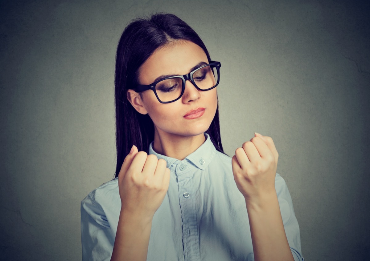 woman looking at fingers nails obsessing about cleanliness