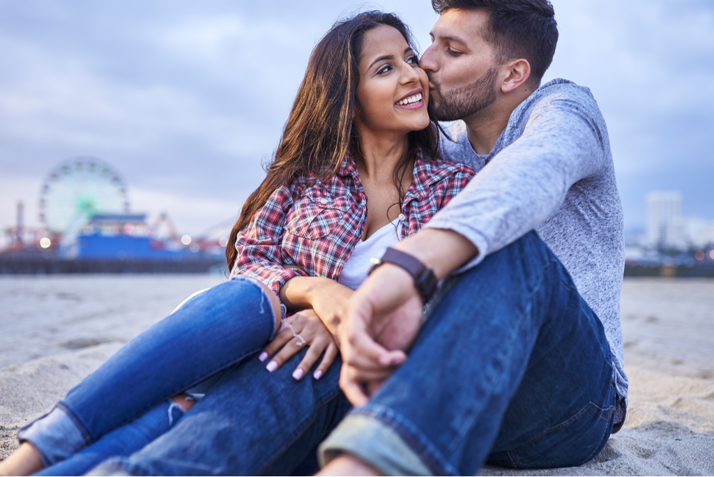 Man Giving Woman Kiss on Cheek Romance