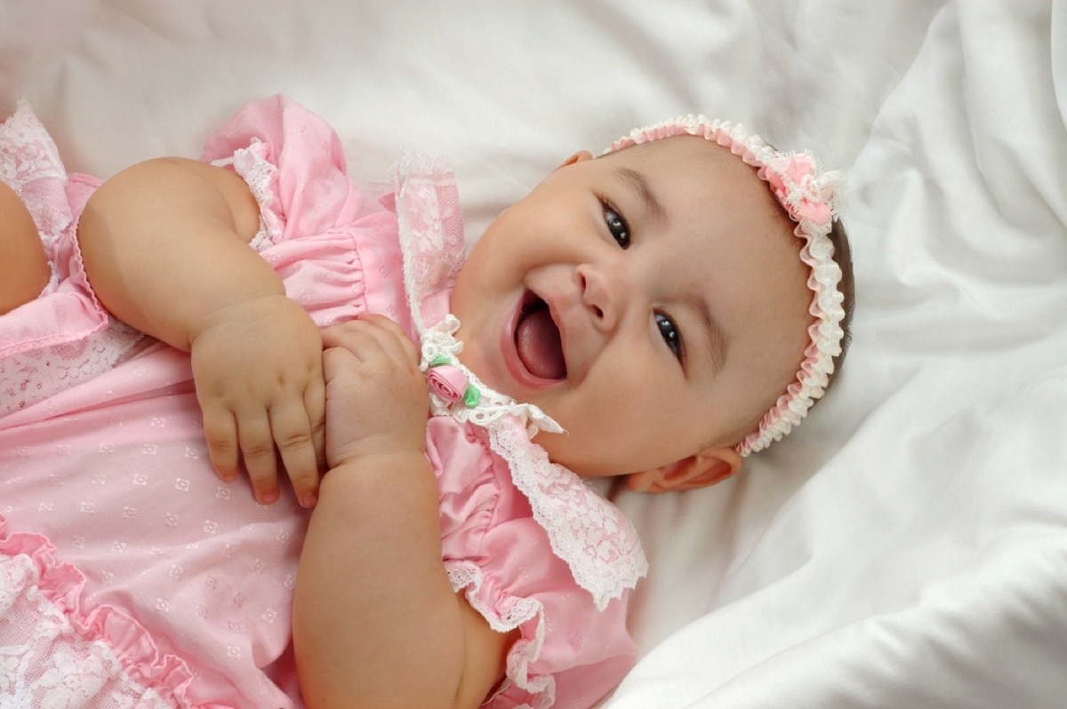 baby girl laughing in pink dress, parenting tips