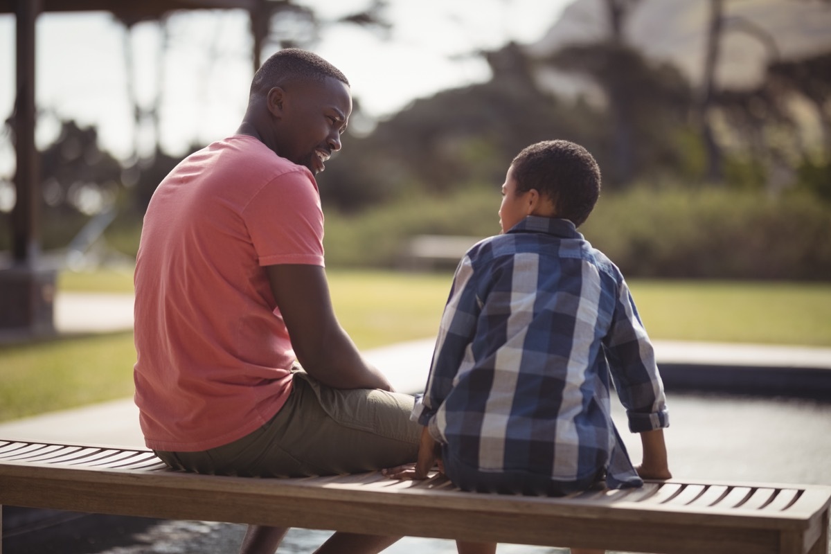 a father sitting down next to his son child and talking, prepare children for divorce