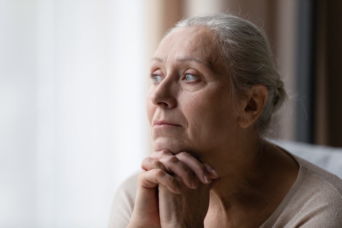 older woman looking out the window