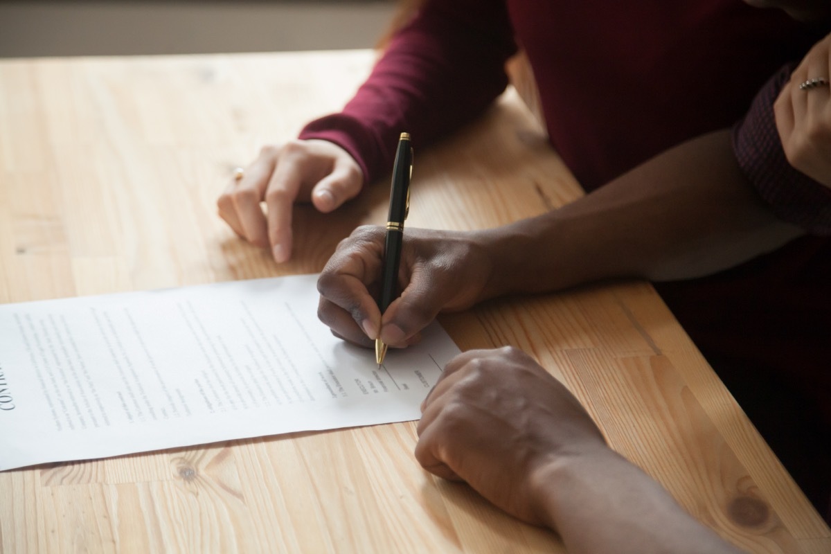 couple signing a prenup