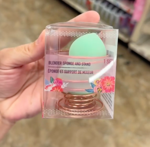 A shopper holds a blending sponge cup in Dollar Tree while shopping for the best Mother's Day gifts.