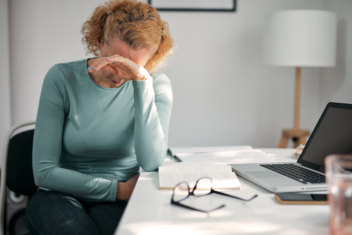 sad woman putting her face in her hands