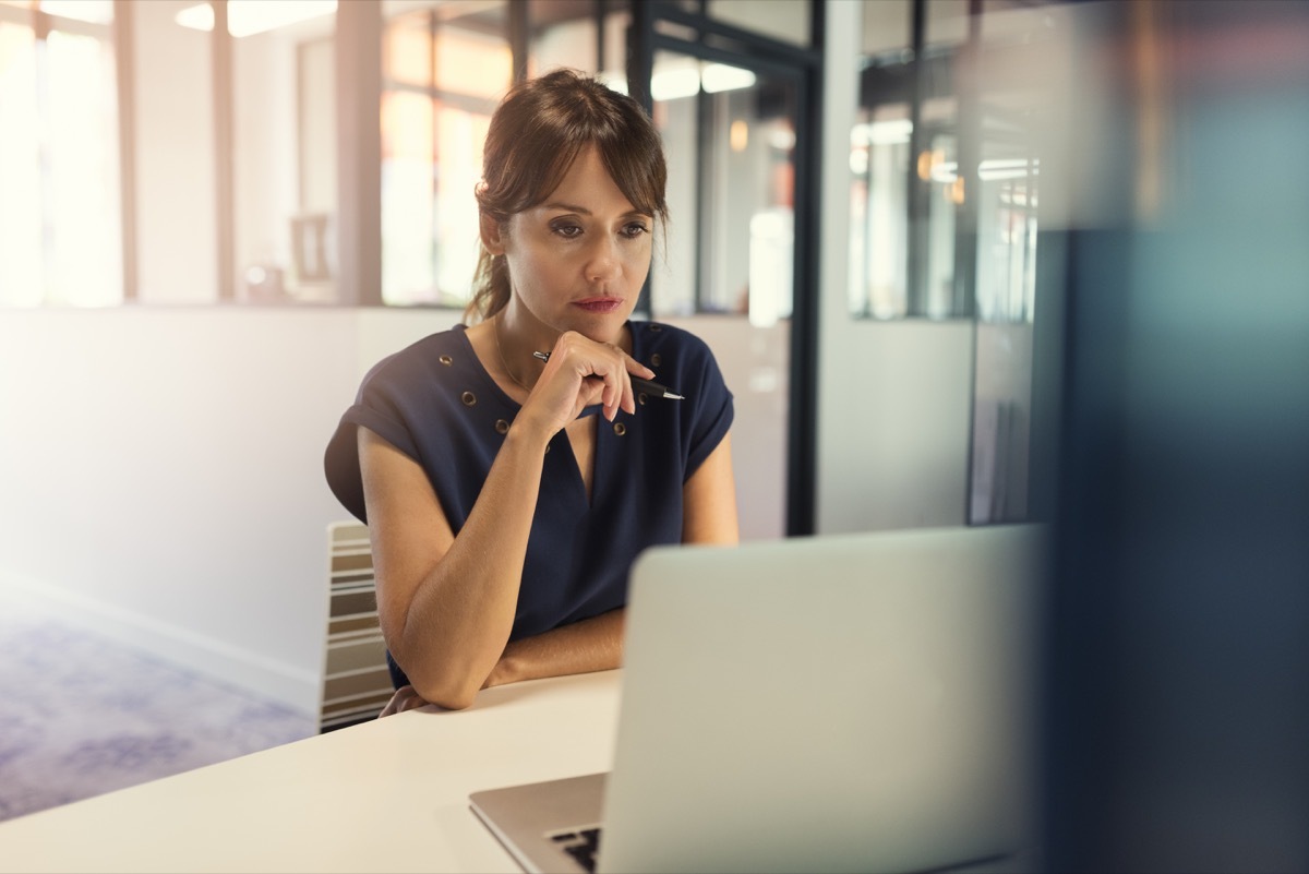 Concentrated middle aged woman working on her computer