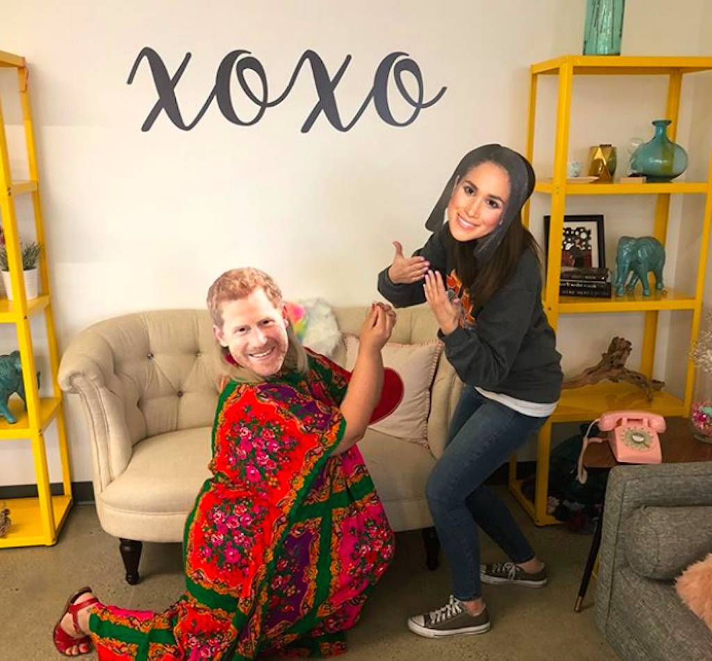 couple gets engaged in megan and harry paper masks. 