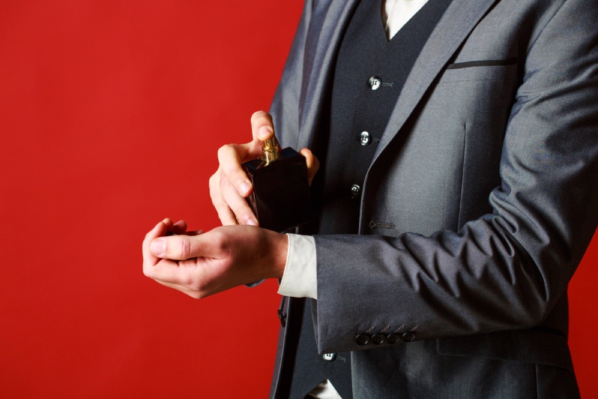 man spraying cologne on wrist, make yourself more attractive