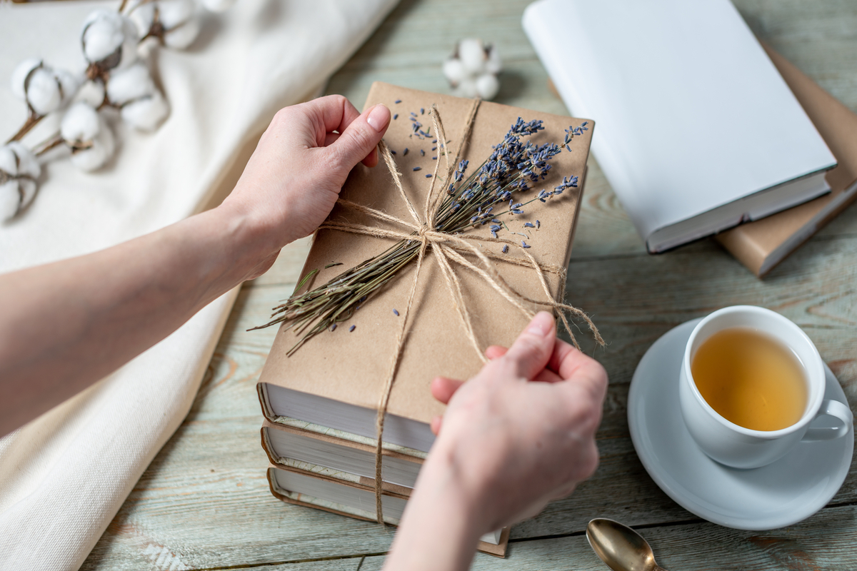 Woman wrapping books as gifts