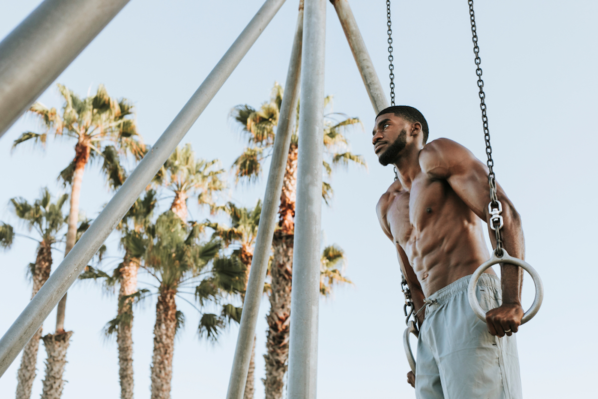 black man using beach gym