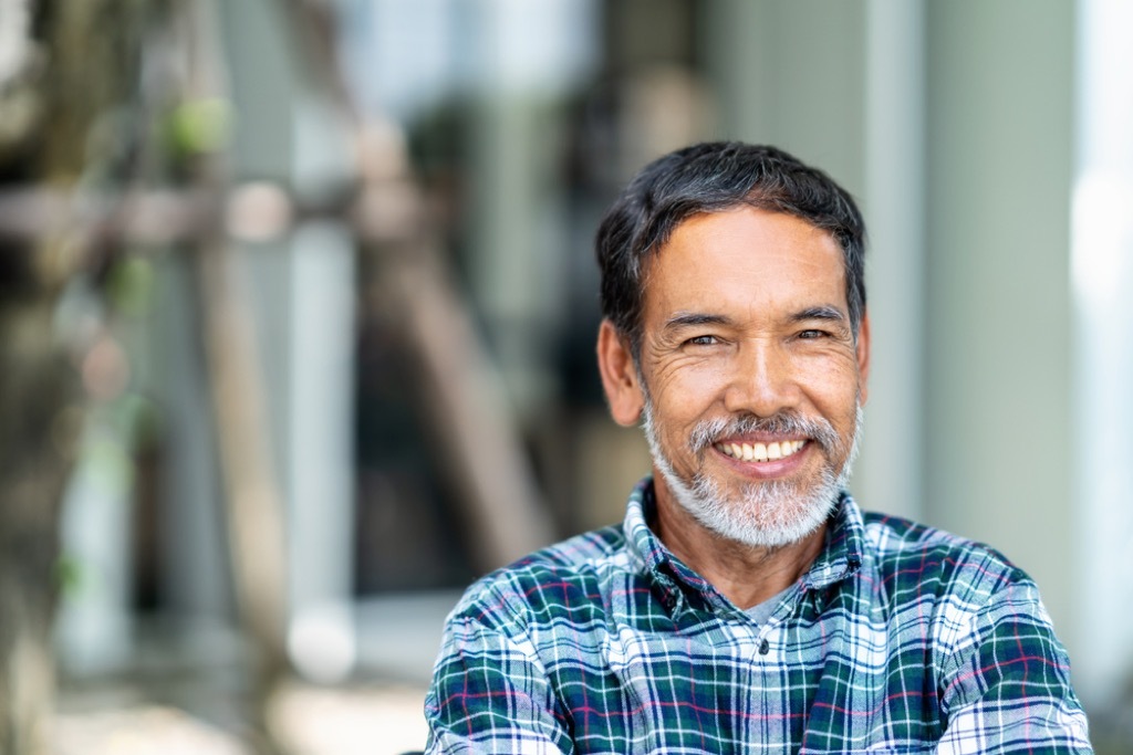 older man smiling outdoors