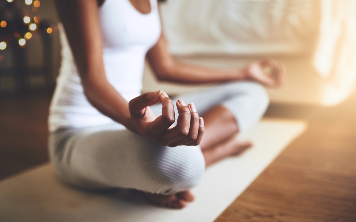 close up of black woman meditating at home