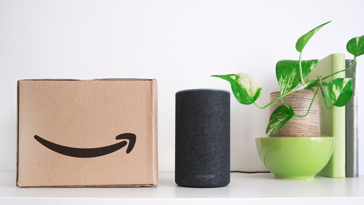 BARCELONA - SEPTEMBER 2018: Amazon Echo Smart Home Alexa Voice Service next to an order in a cardboard box in a living room on September 25, 2018 in Barcelona.