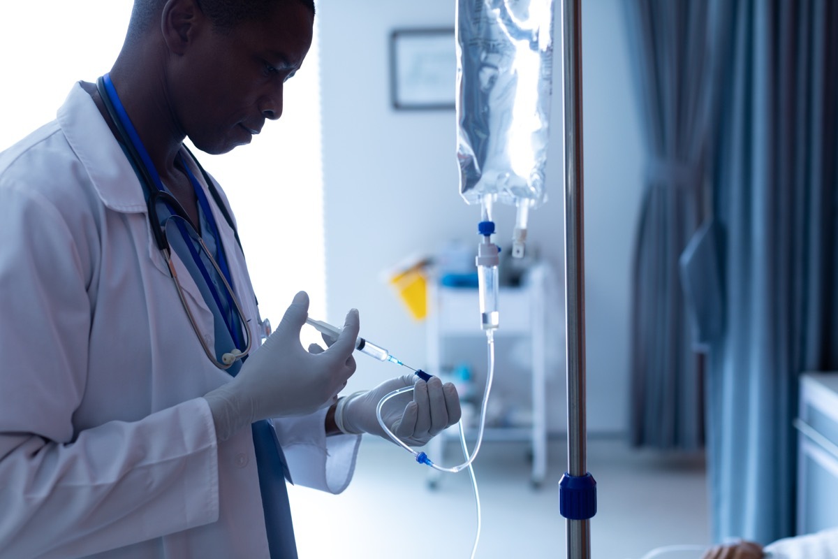 male doctor injecting injection to female patients intravenous drip in the ward at hospital