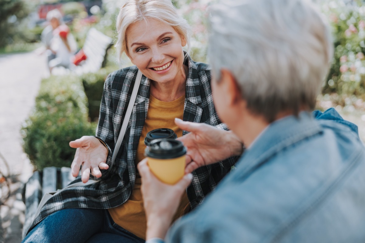 Two mature women talking in park