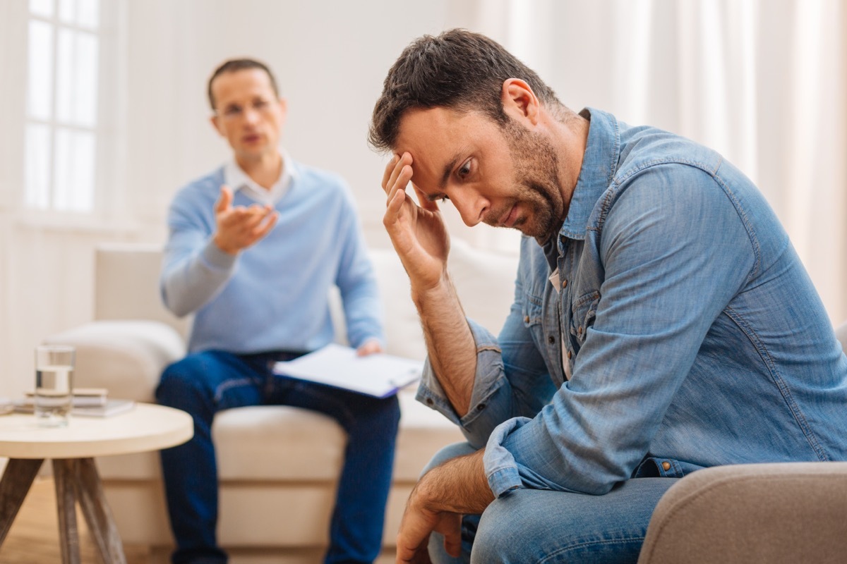 man looking down during conversation